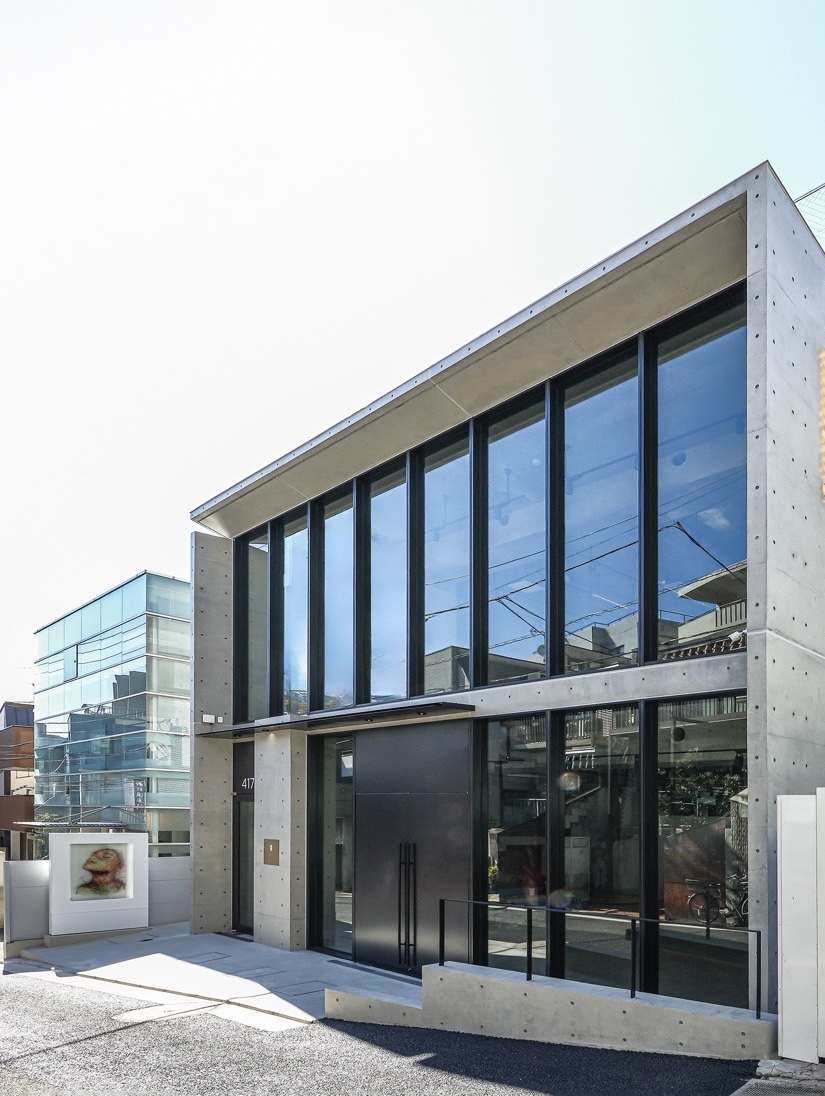Stylish retail building exterior with large glass windows and exposed concrete