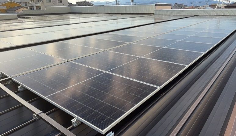 A close-up of solar panels installed on a metal roof.